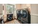 Laundry room with front loading washer and dryer, hardwood floors and natural light at 2917 Townley Cir, Atlanta, GA 30340