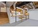 Unfinished basement featuring workbench and stairs to another floor at 3751 Cherokee Se Pl, Marietta, GA 30067