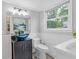 Chic powder room boasting a modern vanity, unique vessel sink, and a window with natural light at 3751 Cherokee Se Pl, Marietta, GA 30067