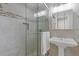 Updated bathroom with glass shower, pedestal sink and decorative accent tiles at 3751 Cherokee Se Pl, Marietta, GA 30067