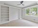 Cozy bedroom with built-in shelving and large windows overlooking a beautiful yard at 3751 Cherokee Se Pl, Marietta, GA 30067