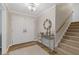 Welcoming foyer with stylish light fixture, double entry doors and view of the staircase at 3751 Cherokee Se Pl, Marietta, GA 30067