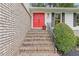 Close-up of the front entrance, showcasing the brick steps and the bold red double doors at 3751 Cherokee Se Pl, Marietta, GA 30067