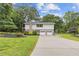 Exterior view of the home featuring a two-car garage and beautiful landscaping at 3751 Cherokee Se Pl, Marietta, GA 30067