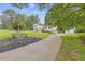 Exterior view of home, with a long driveway and well-maintained landscaping at 3751 Cherokee Se Pl, Marietta, GA 30067