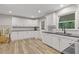 Spacious kitchen with white cabinets, black countertops, and hardwood flooring at 3751 Cherokee Se Pl, Marietta, GA 30067