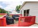 Back deck features a vibrant red railing, table, and black covered grill perfect for outdoor relaxing at 40 Oak Hill Dr, Covington, GA 30016