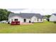 Expansive backyard with a patio, deck, and lush lawn is perfect for outdoor activities and relaxation at 40 Oak Hill Dr, Covington, GA 30016