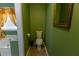 Bathroom featuring toilet, large gold mirror, and window to the tub at 40 Oak Hill Dr, Covington, GA 30016