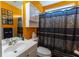 Inviting bathroom showcasing orange walls and patterned shower curtain at 40 Oak Hill Dr, Covington, GA 30016