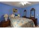 Cozy bedroom featuring colorful bed, a painting, and wooden dressers at 40 Oak Hill Dr, Covington, GA 30016