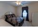 Bedroom featuring a comfortable bed, ceiling fan, and window with dark curtains at 40 Oak Hill Dr, Covington, GA 30016