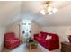 Cozy bonus room with unique patterned ceiling, red sofa and red patterned chair at 40 Oak Hill Dr, Covington, GA 30016