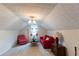 Cozy bonus room with unique patterned ceiling, red sofa and red patterned chair at 40 Oak Hill Dr, Covington, GA 30016