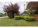 Landscaped Oak Hill community sign with brick base and lush green foliage on a cloudy day at 40 Oak Hill Dr, Covington, GA 30016