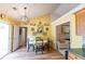 Bright dining area features modern light fixture, hardwood floor and multiple windows at 40 Oak Hill Dr, Covington, GA 30016