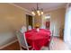 Bright dining room featuring a chandelier, table with seating, and access to the outdoors at 40 Oak Hill Dr, Covington, GA 30016