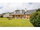 Charming brick home featuring a welcoming front porch, yellow shutters, and lush green lawn at 40 Oak Hill Dr, Covington, GA 30016