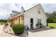 Exterior side view of home with brick accents, yellow shutters, and an outdoor seating area at 40 Oak Hill Dr, Covington, GA 30016