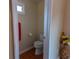 A cozy half bathroom featuring a toilet and small window at 40 Oak Hill Dr, Covington, GA 30016