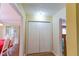 Hallway view showcasing a double-door closet and seamless access to the adjacent dining room at 40 Oak Hill Dr, Covington, GA 30016