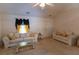 Vaulted ceiling living room with comfortable sofas, a glass coffee table, and neutral carpeting at 40 Oak Hill Dr, Covington, GA 30016
