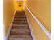 Stairway leading up to the second floor with carpeted stairs and yellow walls at 40 Oak Hill Dr, Covington, GA 30016