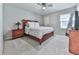 Comfortable bedroom with a ceiling fan, plush carpet, and natural light from the window at 708 Hanover Se Ln, Marietta, GA 30067