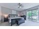 Serene bedroom with a ceiling fan, neutral tones, and a sliding glass door to a private balcony at 708 Hanover Se Ln, Marietta, GA 30067