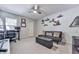 Bedroom with a ceiling fan, plush carpet, and a black futon with storage at 708 Hanover Se Ln, Marietta, GA 30067