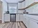 Bright kitchen with white cabinetry, stainless steel appliances, and stylish wood-look flooring at 708 Hanover Se Ln, Marietta, GA 30067