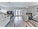 Bright living room with a fireplace, stylish seating, and French doors to the outside at 708 Hanover Se Ln, Marietta, GA 30067