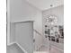 View of the staircase with unique light fixture and decorated with movie posters at 708 Hanover Se Ln, Marietta, GA 30067