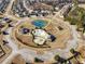 Aerial view of the community amenities featuring a tennis court, splash pad, and well-manicured green spaces at 2528 Shropshire Pl, Mcdonough, GA 30253