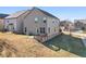 View of the home's back elevation, including a concrete patio and a small wooden deck overlooking the yard at 2528 Shropshire Pl, Mcdonough, GA 30253