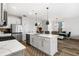 Bright kitchen boasting white cabinetry, an island with seating, and stainless steel appliances, adjacent to dining area at 2528 Shropshire Pl, Mcdonough, GA 30253