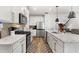 Modern kitchen featuring white cabinets, stainless steel appliances, and a functional island with pendant lighting at 2528 Shropshire Pl, Mcdonough, GA 30253