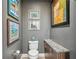 Chic powder room with elegant granite counter, stylish fixtures, and attractive art adorning the gray walls at 270 17Th Nw St # 3606, Atlanta, GA 30363