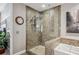 Bright bathroom with a glass-enclosed shower, tiled walls, and a soaking tub, offering a refreshing and luxurious space at 270 17Th Nw St # 3606, Atlanta, GA 30363