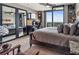 Well-lit bedroom featuring a comfortable bed, city views, and mirrored closet doors for added space and style at 270 17Th Nw St # 3606, Atlanta, GA 30363