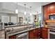 Open-concept kitchen with stainless steel appliances, granite countertops, and cherry wood cabinetry at 270 17Th Nw St # 3606, Atlanta, GA 30363