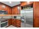 Modern kitchen featuring stainless steel appliances, granite countertops, cherry cabinets at 270 17Th Nw St # 3606, Atlanta, GA 30363