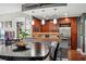 Modern kitchen featuring stainless steel appliances, granite countertops, and dark wood cabinetry at 270 17Th Nw St # 3606, Atlanta, GA 30363