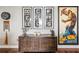 Eclectic decor in a living space featuring unique artwork, hardwood flooring, and a modern cabinet at 270 17Th Nw St # 3606, Atlanta, GA 30363