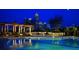 A swimming pool is reflecting the city lights, surrounded by lounge chairs and tables at 270 17Th Nw St # 3606, Atlanta, GA 30363