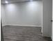 Basement featuring wood-style floors, bright lighting, and white paneled walls at 421 Congress Pkwy, Lawrenceville, GA 30044