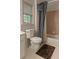 Bathroom featuring a toilet, bathtub with shower curtain, and tiled walls and floor at 421 Congress Pkwy, Lawrenceville, GA 30044