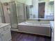 A bright bathroom with a bathtub, shower, and white cabinets with a sink at 421 Congress Pkwy, Lawrenceville, GA 30044