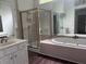 Bathroom featuring double vanity, tiled shower, soaking tub, and abundant counter space at 421 Congress Pkwy, Lawrenceville, GA 30044