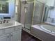 Bathroom featuring a glass enclosed shower, soaking tub, and spacious vanity at 421 Congress Pkwy, Lawrenceville, GA 30044